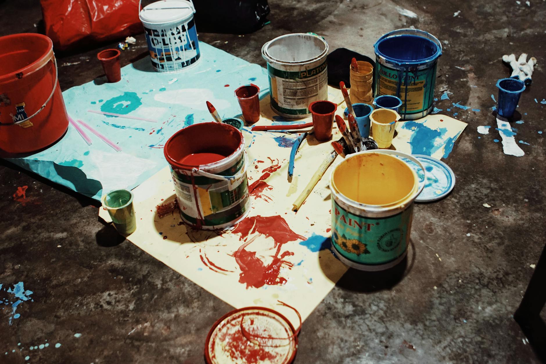 paint cans and brushes on papers